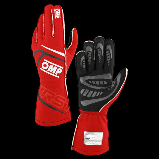 A pair of red OMP 'FIRST' circuit racing gloves with black detailing and the OMP logo visible.