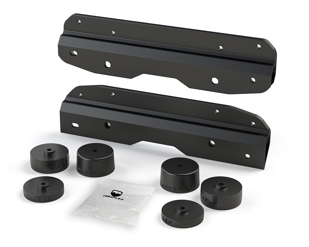 A black metal bracket kit, including various spacers and mounting hardware, designed for relocating the spare tire on a Jeep Wrangler JL or JLU.