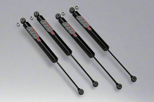 A set of four Teraflex 9550 2.5" lift shocks for Wrangler JL / JLU 2019+ vehicles, displayed against a grey background.